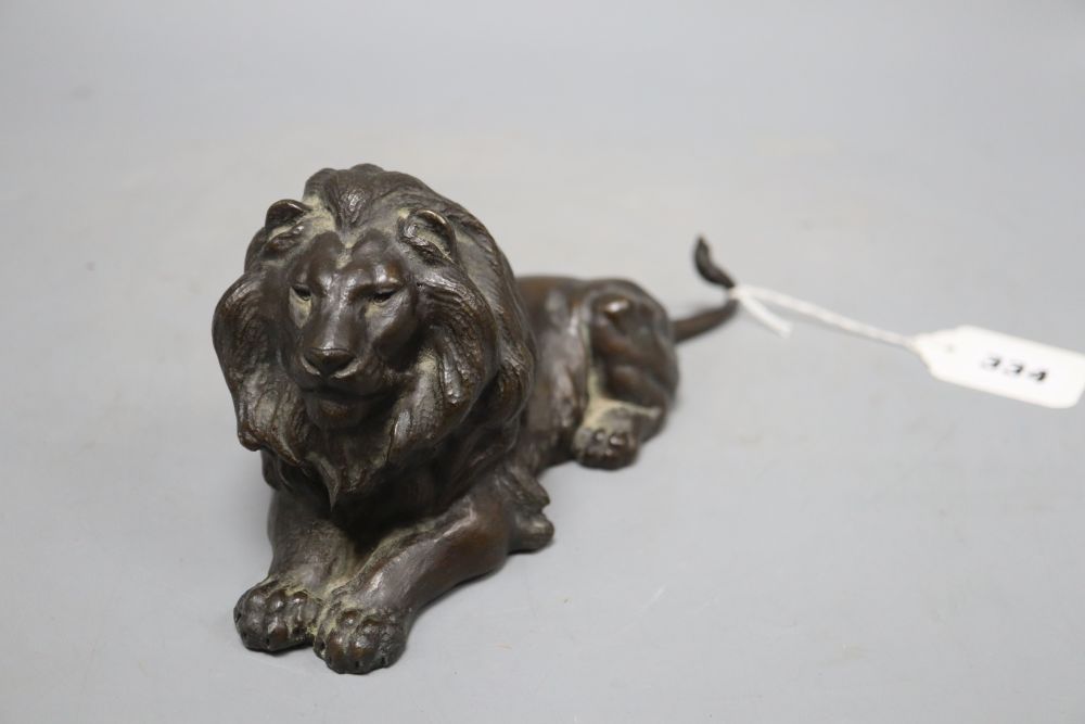 An early 20th century bronze model of a recumbent lion, length 23cm